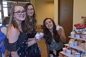 Three girls bonding over some treats in the lobby